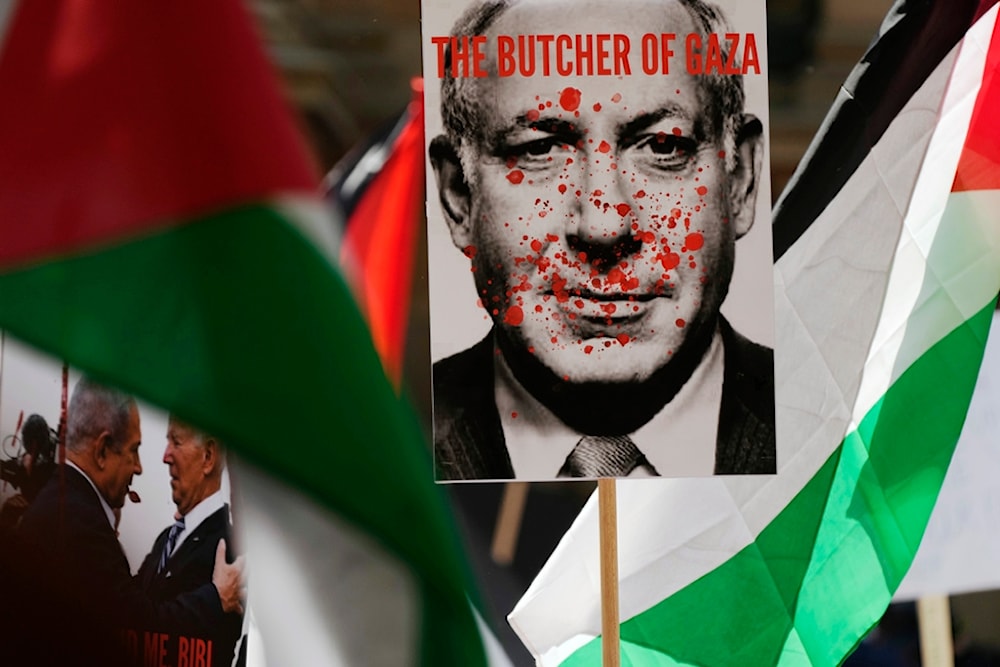 Posters showing Israeli Prime Minister Benjamin Netanyahu and then-US President Joe Biden are carried among Palestinian flags during a pro-Palestinian rally in Sydney, Australia, Oct. 21, 2023 (AP)