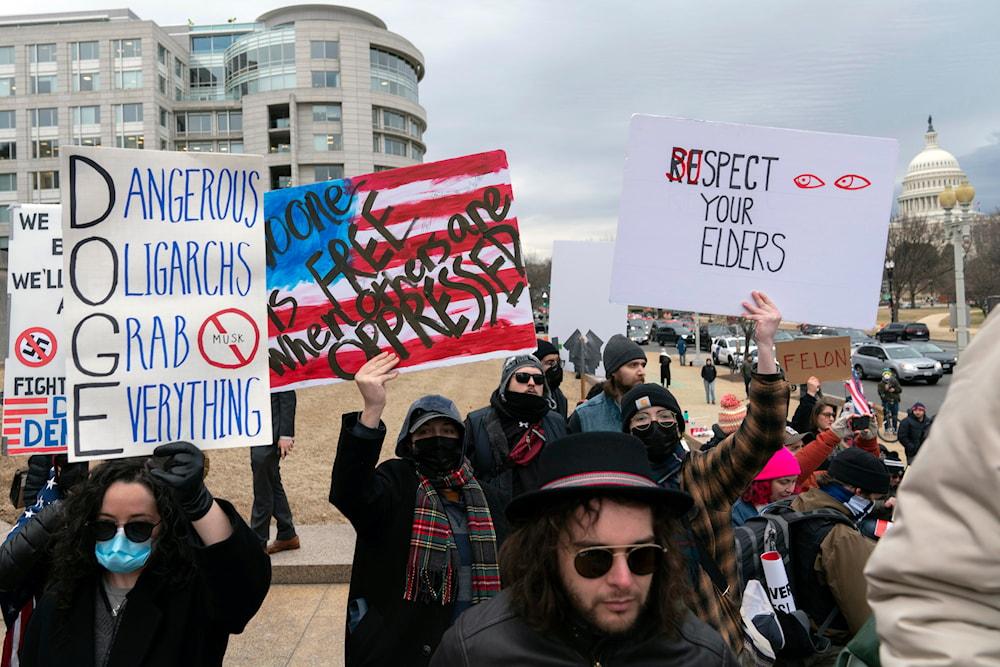 People protest during a rally against Elon Musk outside the U.S. Department of Labor in Washington, Wednesday, Feb. 5, 2025. (AP)