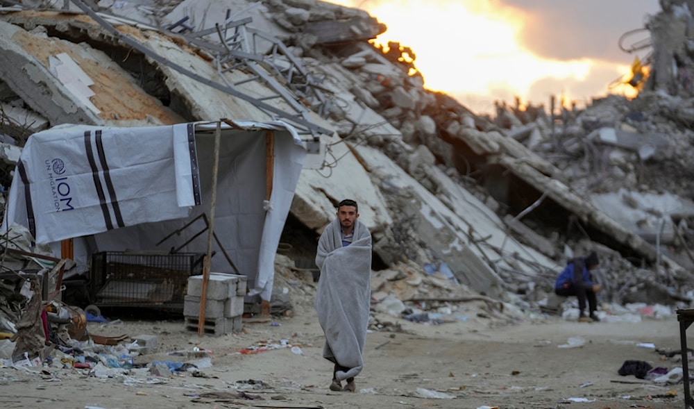 Palestinians walk in the destruction caused by the Israeli genocide in Jabalia, Gaza Strip, Wednesday, Feb. 5, 2025. (AP)