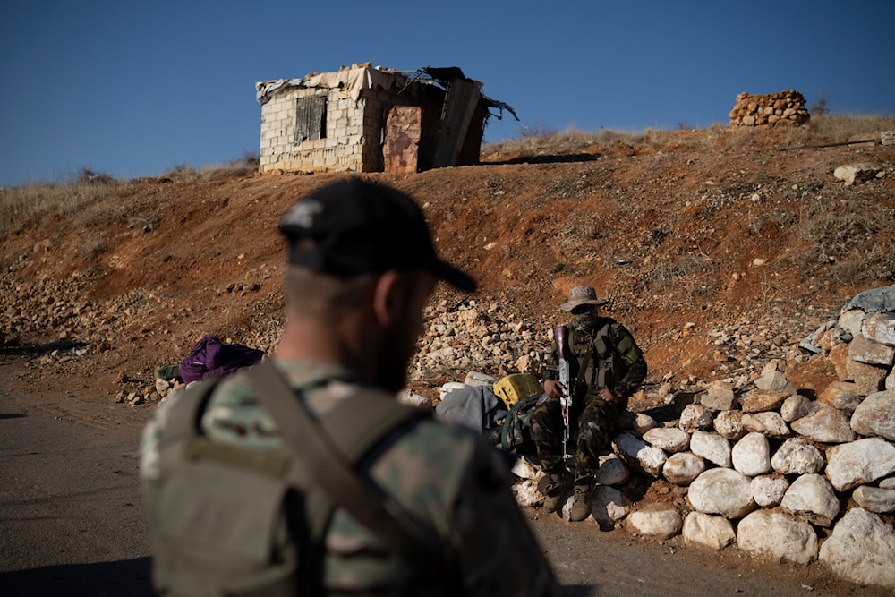 Members of the new security forces stand guard at a checkpoint located near the border with Lebanon, in the town of Serghaya, Syria, Tuesday, Jan. 7, 2025. (AP )