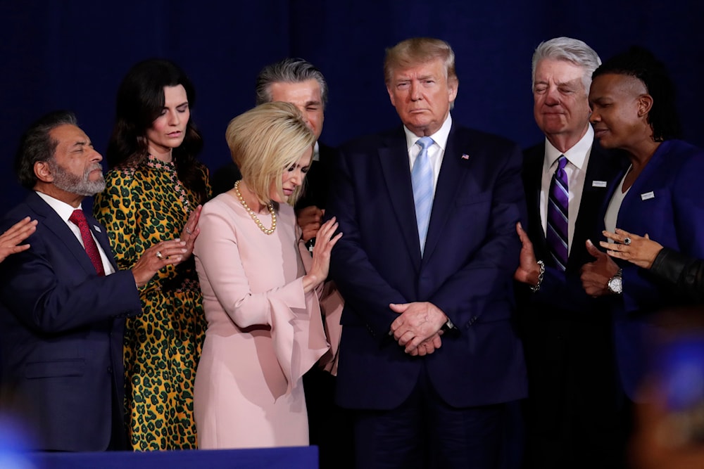 In this Jan. 3, 2020 file photo, evangelical supporters pray with President Donald Trump during a rally at the King Jesus International Ministry church in Miami. (AP)