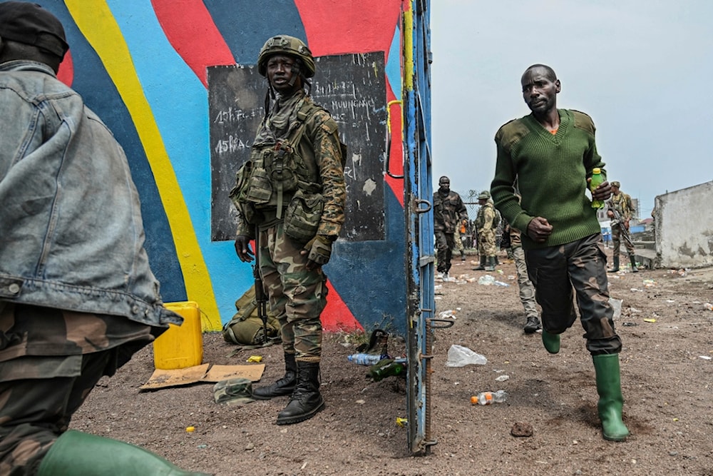 Government soldiers and police officers who surrendered to M23 rebels, center, run to board trucks to an undisclosed location in Goma, Democratic Republic of the Congo, Thursday, Jan. 30, 2025 (AP)