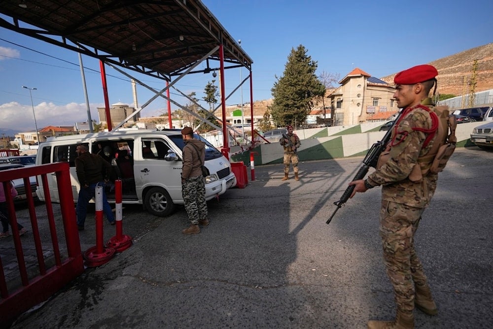 People crosses into Syria through the Masnaa border crossing point in the Bekaa Valley, Lebanon, Sunday, Dec. 8, 2024 (AP)