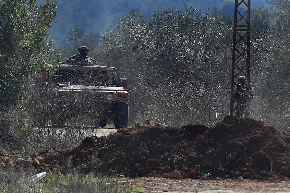 A Lebanese soldier stands guard on a road blocked by Israeli soldiers, where citizens gather to return to their villages near the southern Lebanese village of Kfar Kila, Lebanon, Sunday, Feb. 2, 2025 (AP)