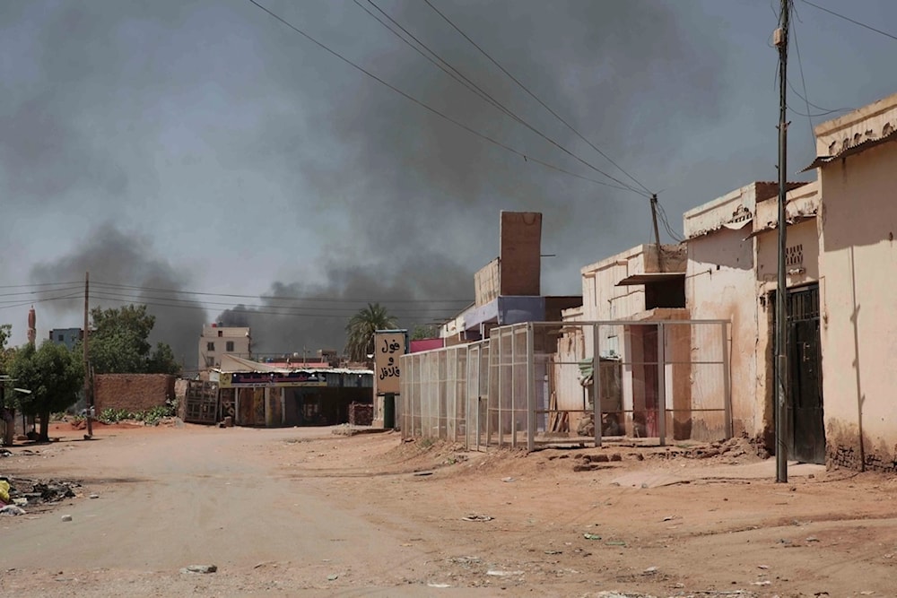 Smoke rises in Khartoum, Sudan, Wednesday, May 3, 2023. Many people are fleeing the conflict in Sudan between the military and a rival paramilitary force. (AP Photo/Marwan Ali)