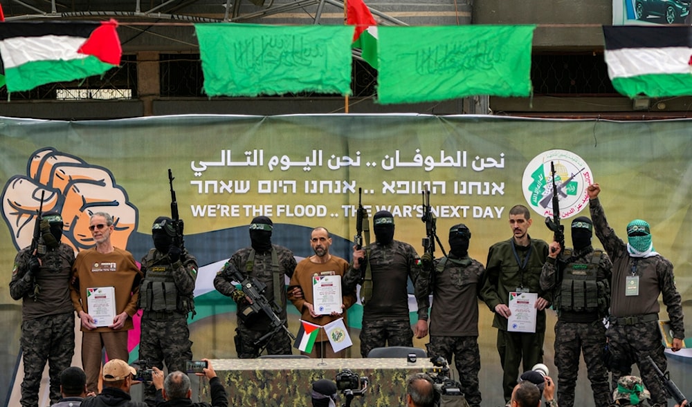 Israeli captives are escorted by Hamas fighters before being handed over to the Red Cross in Deir al-Balah, central Gaza Strip, Saturday Feb. 8, 2025. (AP)