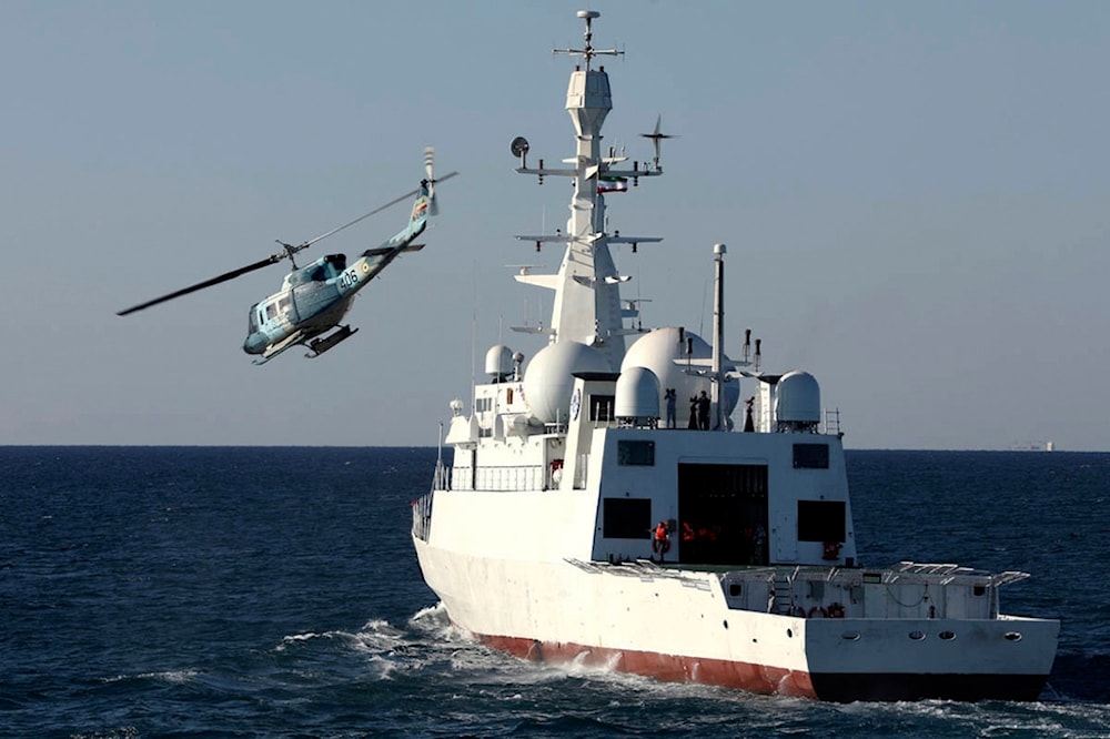 In this picture released by the official website of the Iranian Army on Wednesday, Jan 15, 2025, a helicopter flies over domestically-built signals intelligence Zagros ship that joined the navy fleet in the Gulf of Oman (Iranian Army via AP)