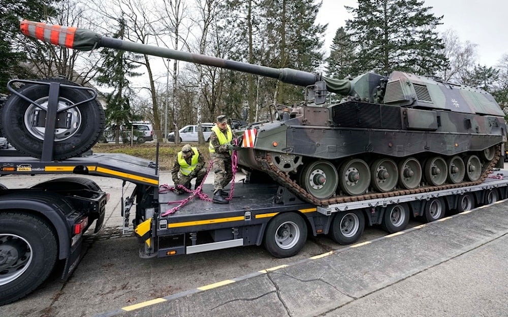 FILE - German soldiers load tank howitzers for transport to Lithuania at the Bundeswehr army base in Munster, northern Germany, Monday, Feb. 14, 2022. (AP Photo/Martin Meissner, File)