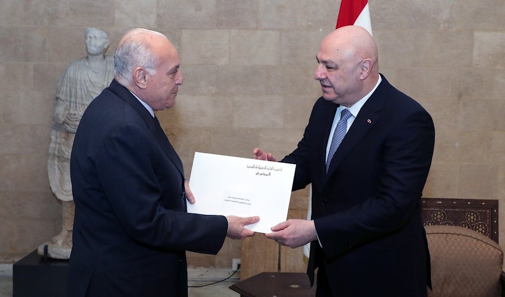 Algerian Foreign Minister Ahmed Attaf hands Lebanese President Joseph Aoun a written letter during their meeting in Baabda, Lebanon, February 9, 2025 (