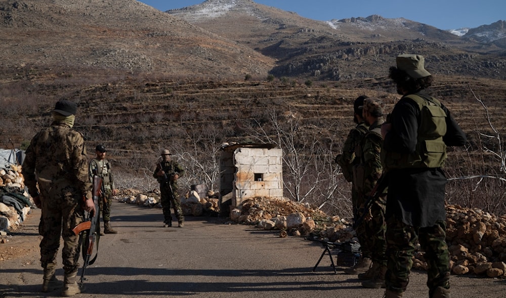 Members of the new security forces stand guard at a checkpoint located near the border with Lebanon, in the town of Serghaya, Syria, Tuesday, Jan. 7, 2025. (AP)