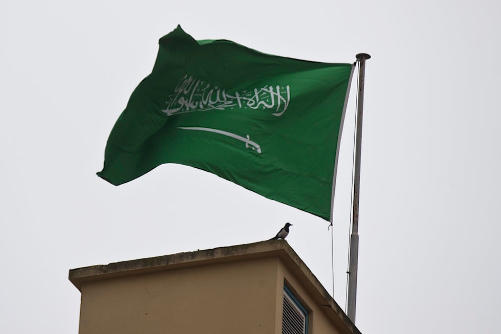 A bird sits by a Saudi Arabia's flag on the roof top of Saudi Arabia's consulate in Istanbul, Sunday, Oct. 14, 2018. (AP)