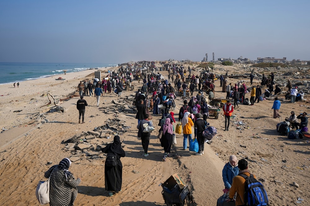 Displaced Palestinians walk on a road in central Gaza to return to their homes in the northern Gaza Strip, Wednesday, Jan. 29, 2025. (AP Photo/Abdel Kareem Hana)