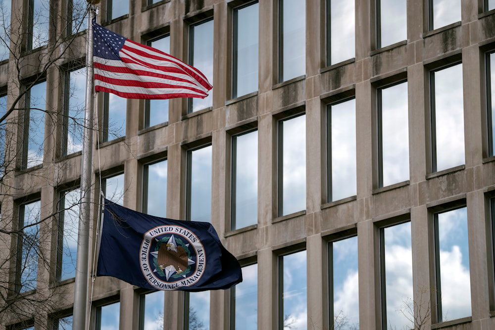 U.S. and agency flags fly outside the Theodore Roosevelt Building, location of the U.S. Office of Personnel Management, on Tuesday, Feb. 13, 2024, in Washington.  (AP)