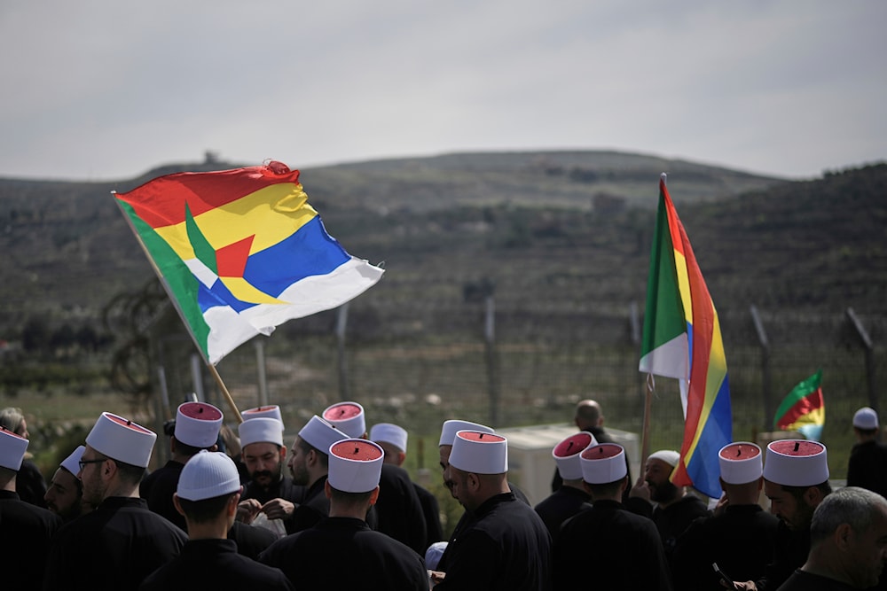 Druze wait for buses carrying members of the Syrian Druze community to cross from Syria in the village of Majdal Shams, in the Israeli-occupied Golan Heights, Friday, March 14, 2025. (AP)