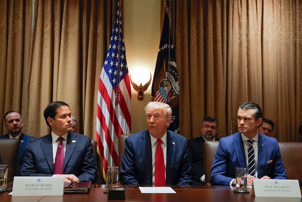 President Donald Trump speaks during a Cabinet meeting at the White House in Washington, Wednesday, Feb. 26, 2025, as Secretary of State Marco Rubio and Defense Secretary Pete Hegseth listen. (Pool via AP)