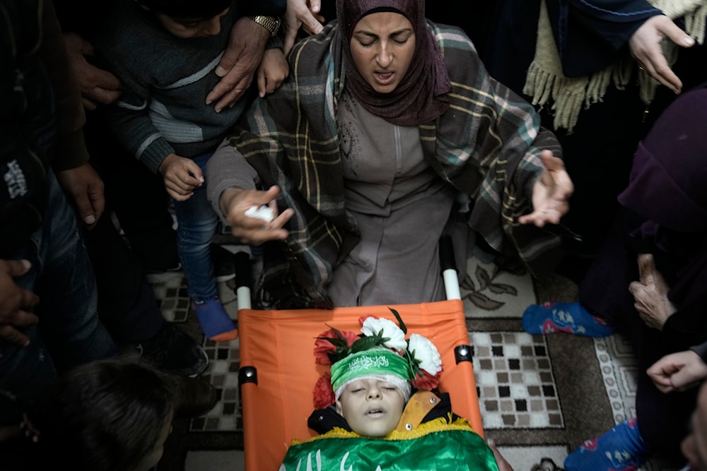 Palestinian mother of Amr al-Najjar, shot in the head by the IOF, weeps during his funeral in the West Bank village of Burin, near Nablus, on Tuesday, March 5, 2024. (AP)