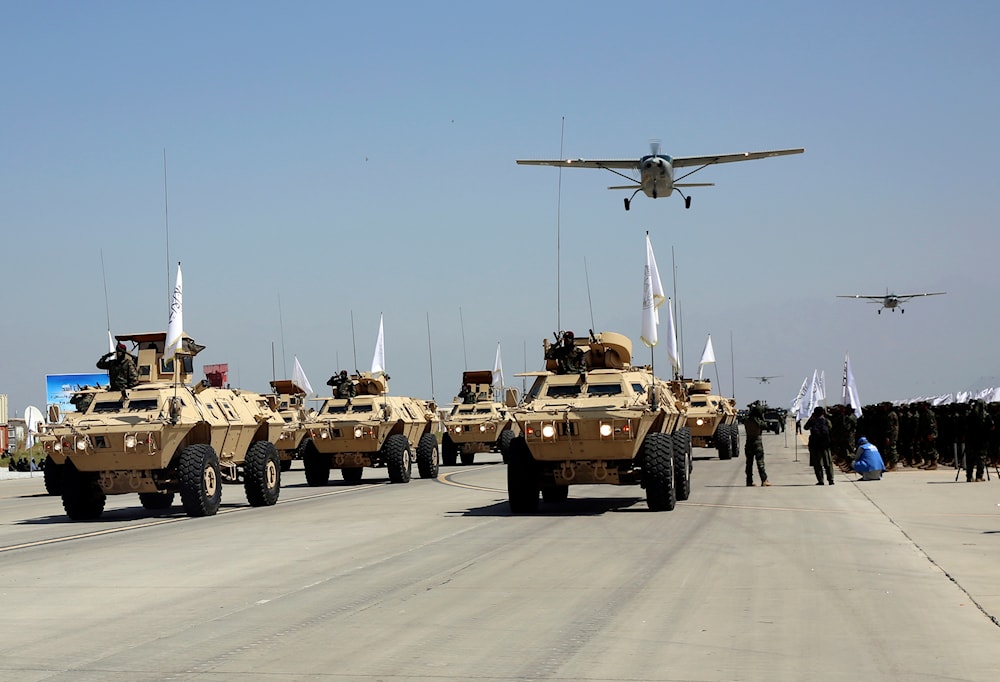 Taliban military vehicles take part in a military parade to mark the third anniversary of the withdrawal of US-led troops from Afghanistan, in Bagram Air Base in the Parwan Province of Afghanistan, Wednesday, Aug. 14, 2024. (AP)