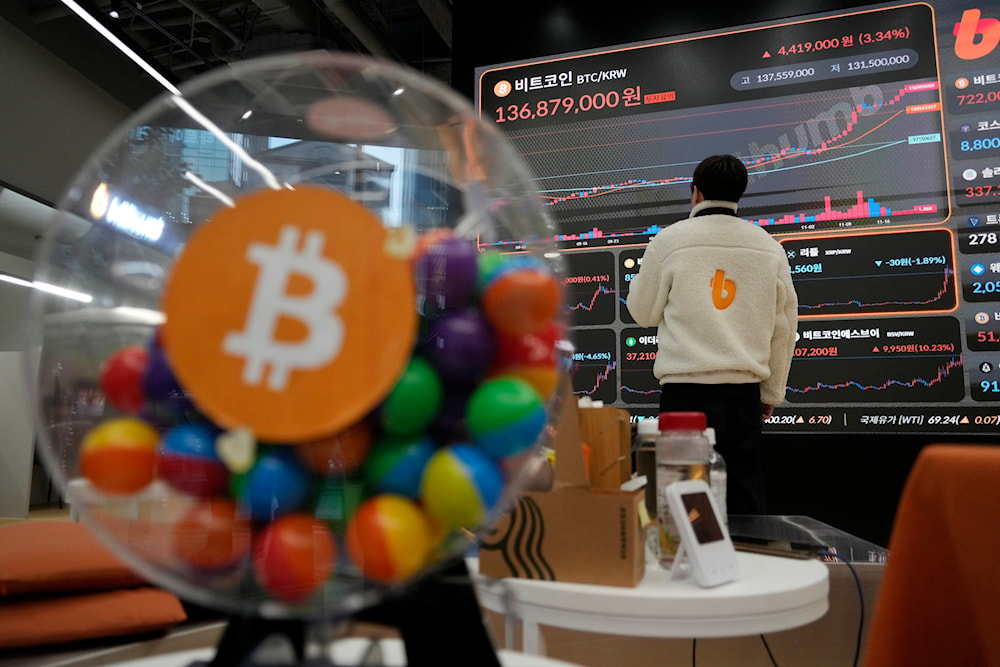 An employee watches an electronic signboard displaying the prices of Bitcoin and other cryptocurrencies at the lounge of Bithumb cryptocurrency exchange in Seoul, South Korea, Nov. 21, 2024. (AP)