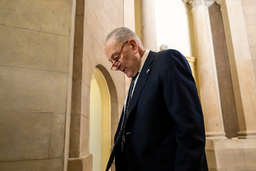 Senate Democratic Leader Chuck Schumer walks near the Senate chamber, as the Senate works to avert a partial government shutdown ahead of the midnight deadline, at the Capitol in Washington, Friday, March 14, 2025. (AP)