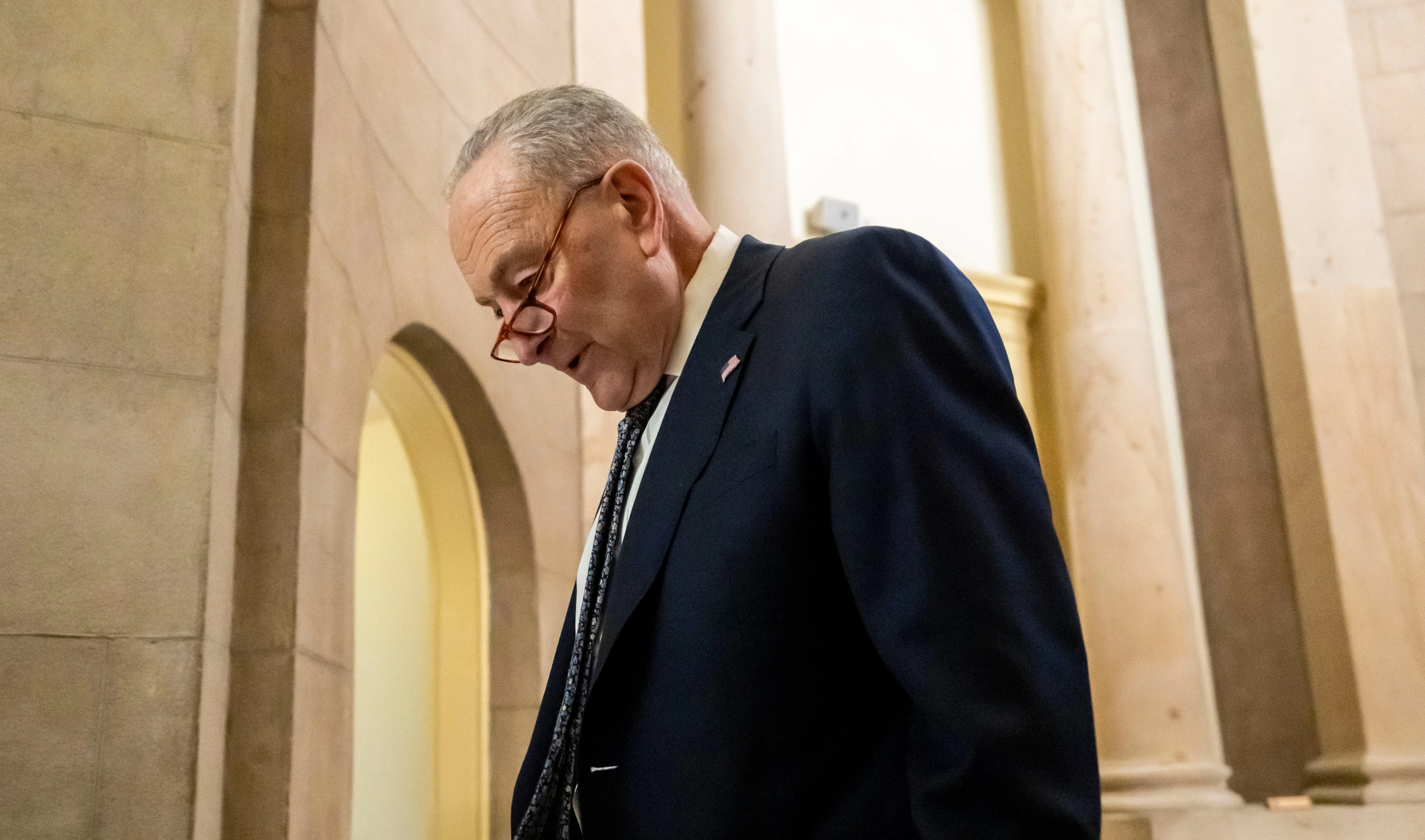 Senate Democratic Leader Chuck Schumer walks near the Senate chamber, as the Senate works to avert a partial government shutdown ahead of the midnight deadline, at the Capitol in Washington, Friday, March 14, 2025. (AP)