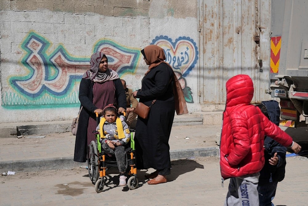 Yasmine al-Ghoufary takes her niece Sila Abu Aqlan, 5, to the Artificial Limbs and Polio Center in Gaza City to learn how to walk with a prosthetic leg, on Wednesday, Feb. 26, 2025 (AP)