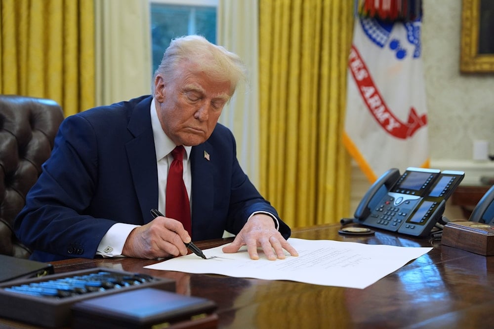 President Donald Trump signs a document in the Oval Office at the White House, Jan. 30, 2025, in Washington. (AP)