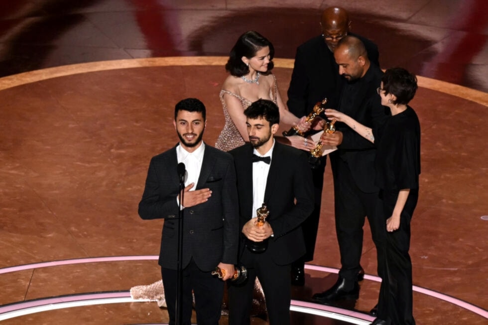 Israeli journalist and filmmaker Yuval Abraham (R) and Palestinian journalist and filmmaker Basel Adra accept the Oscar for Best Documentary Feature for 'No Other Land' on March 2, 2025(AFP)