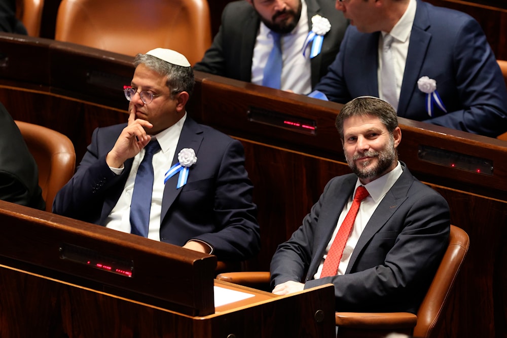 Israeli right wing Knesset member Itamar Ben Gvir, left, and Bezalel Smotrich look on during the swearing-in ceremony for Israeli lawmakers at the Knesset, Israel's parliament, in occupied al-Quds, Tuesday, Nov. 15, 2022. (Pool Photo via AP)