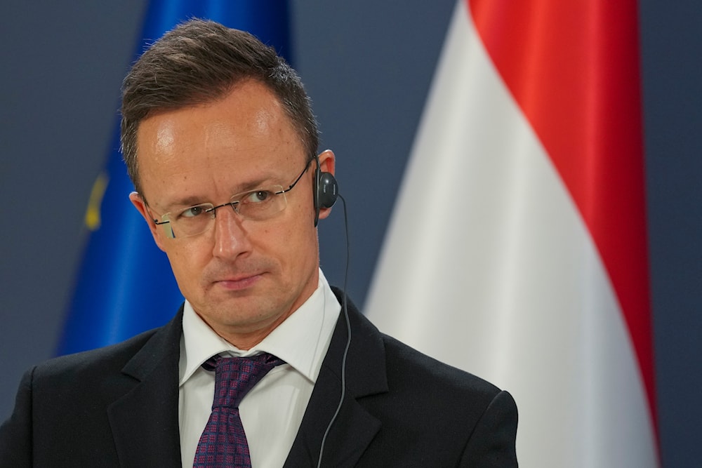 Hungarian Foreign Minister Peter Szijjarto listens his Serbian counterpart Marko Djuric during a press conference in Belgrade, Serbia, Thursday, Feb. 13, 2025. (AP Photo/Darko Vojinovic)