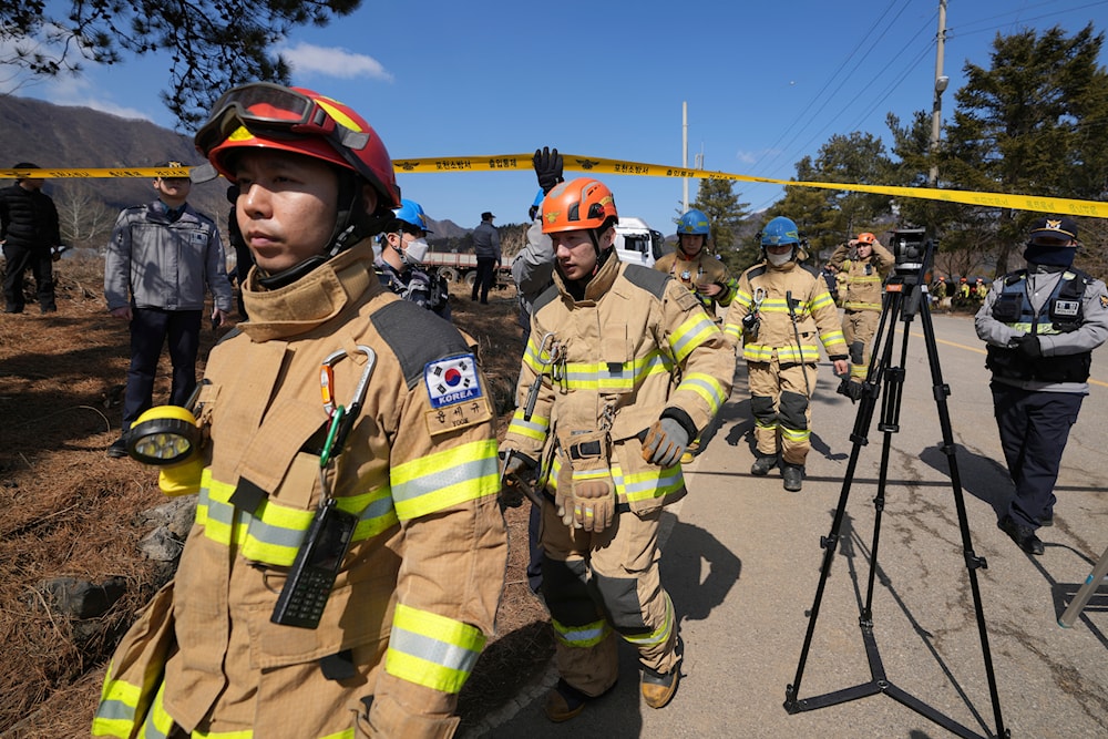 South Korea firefighters move near a bomb accident site where a South Korean fighter jet accidentally dropped bombs on a civilian area during training, in Pocheon, South Korea, Thursday, March 6, 2025. (AP)