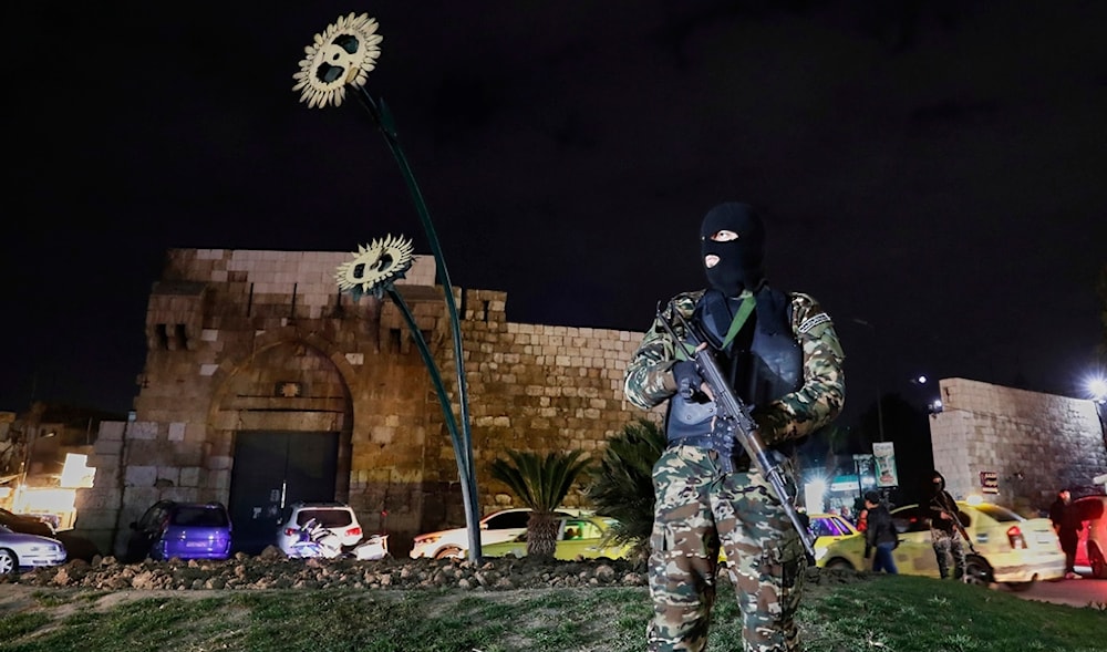 A member of the Syrian government security forces stands guard at a street in Damascus, Syria, Thursday, March 6, 2025. (AP)