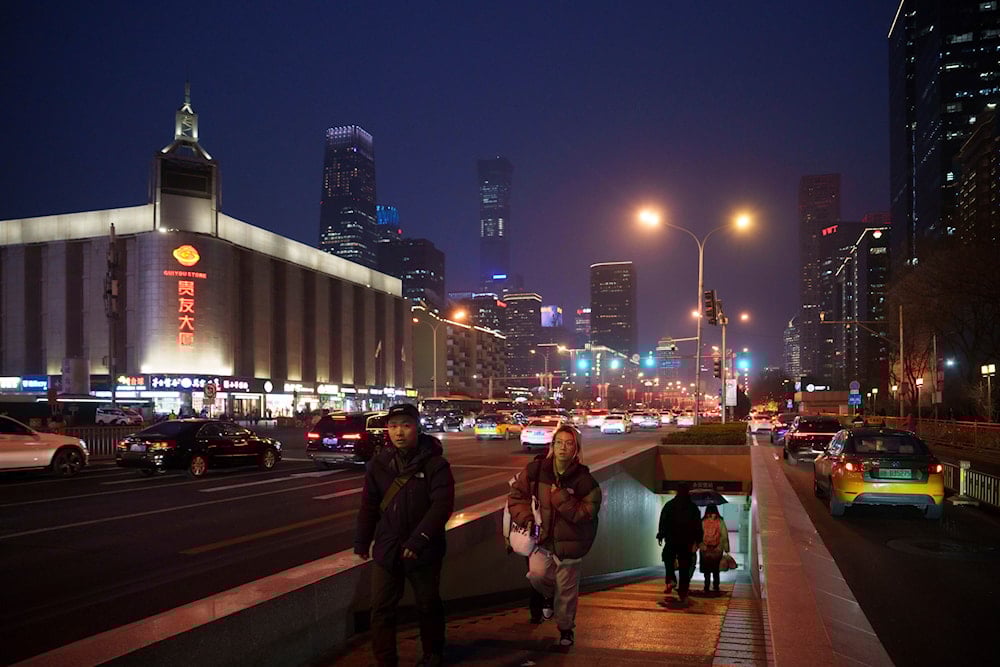 Pedestrian exit an underground tunnel in downtown Beijing, China, Friday, March 7, 2025. (AP)