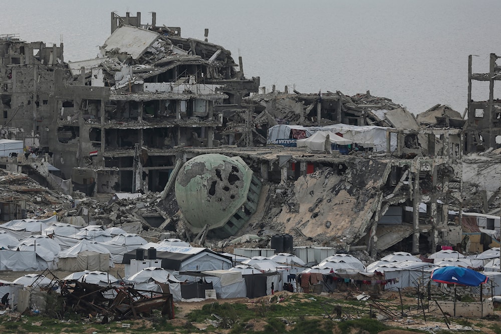 A tent camp for displaced Palestinians is set up amid destroyed buildings in the west of Al-Shati camp, west of Gaza City, on Monday, March 3, 2025. (AP)