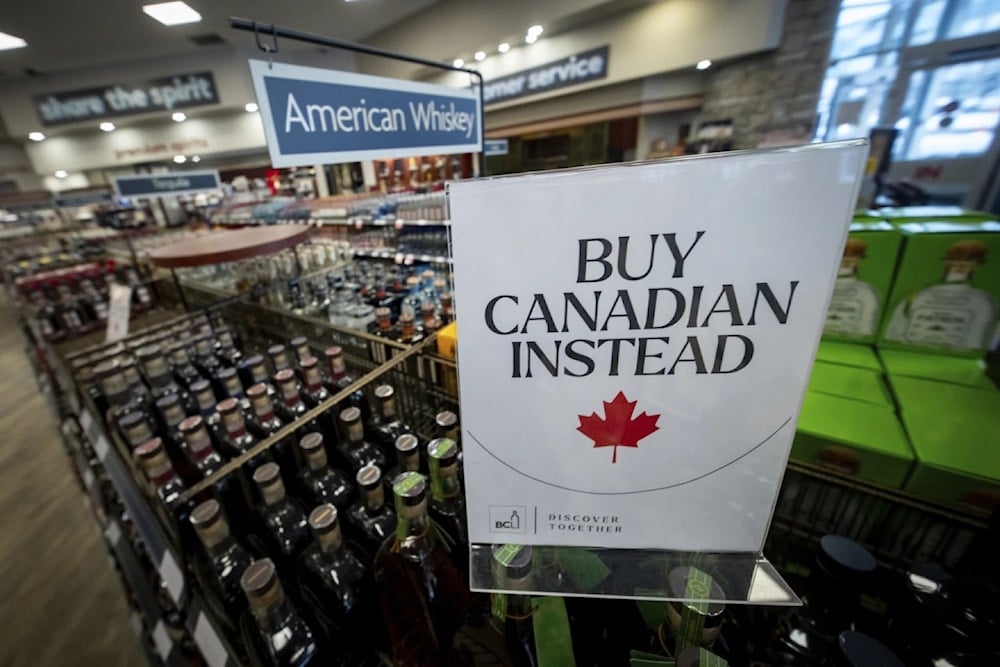 A sign is placed in front of the American whiskey section at a B.C. liquor store after top-selling American made products have been removed from shelves in Vancouver, B.C., Sunday Feb. 2, 2025 (AP)
