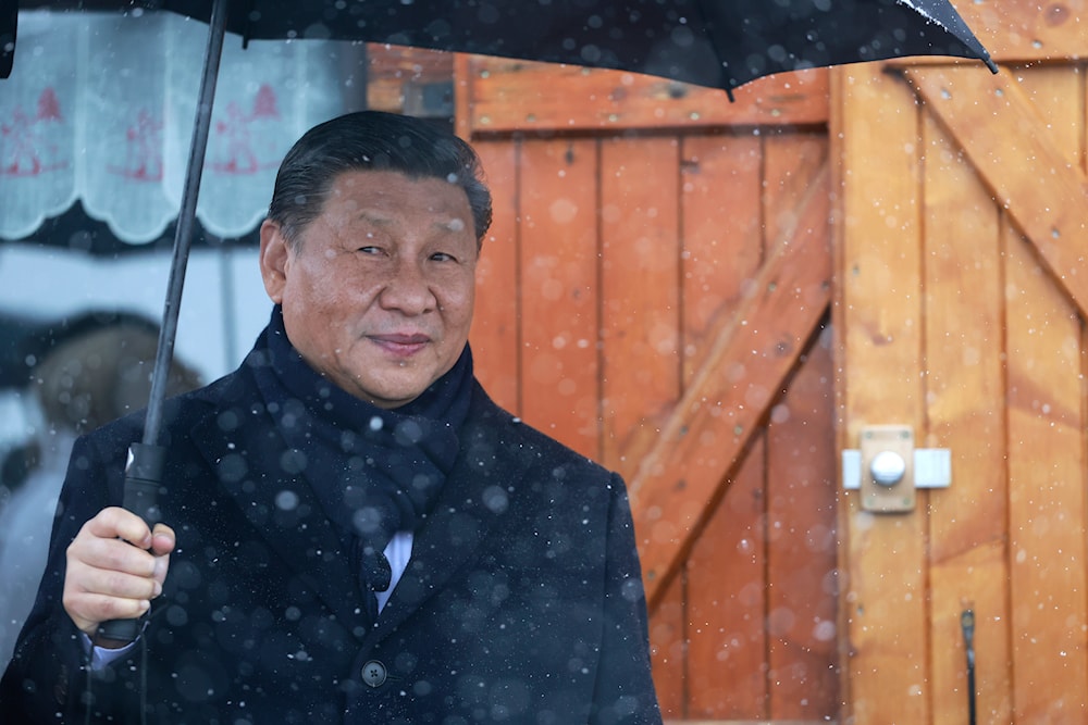 Chinese President Xi Jinping holds an umbrella outside a restaurant Tuesday, May 7, 2024 at the Tourmalet pass, in the Pyrenees mountains. (AP)