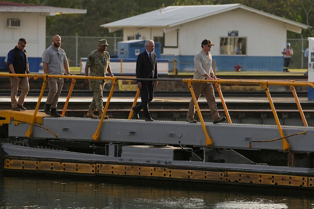 U.S. Defense Secretary Pete Hegseth, right, and Panama Canal Authority Administrator Ricaurte Vasquez, second from right, cross a bridge during a tour of the Panama Canal's Miraflores Locks in Panama City, Tuesday, April 8, 2025. (AP )