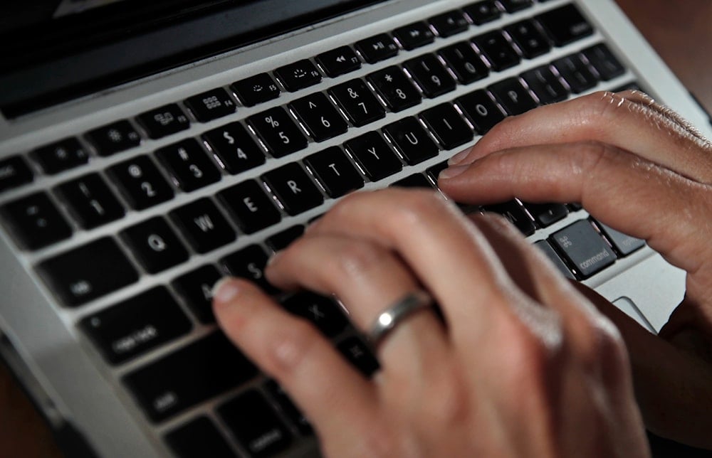 A person types on a laptop keyboard in North Andover, Mass, June 19, 2017. (AP)