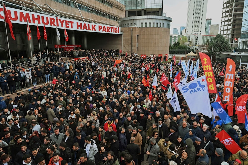 People gather outside the headquarters of the opposition Republican People's Party or (CHP) to protest following the arrest of Istanbul Mayor Ekrem Imamoglu in Ankara, Turkey, on Wednesday, March 19, 2025. (AP Photo/Ali Unal)