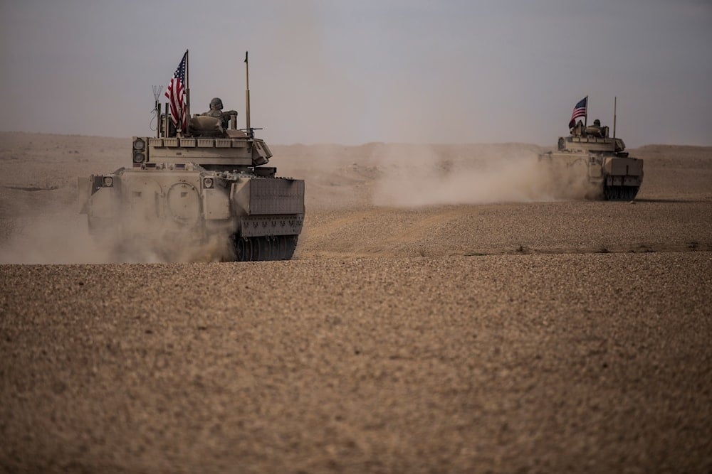 US occupation soldiers drive a Bradley fighting vehicles during a joint exercise with Syrian Democratic Forces at the countryside of Deir Ezzor in northeastern Syria, Wednesday, Dec. 8, 2021. .(AP Photo/Baderkhan Ahmad)