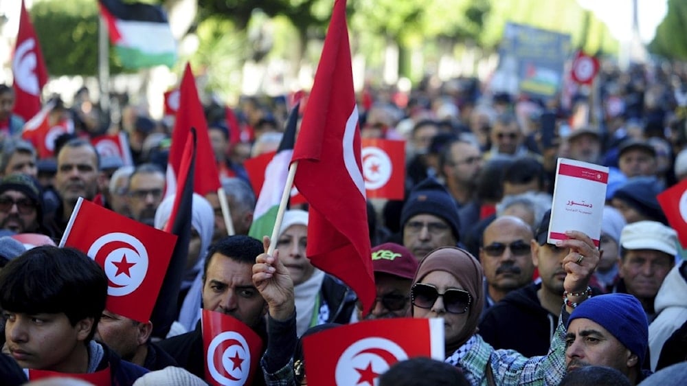 People commemorate the 13th anniversary of the Tunisian uprising in Avenue Habib Bourguiba, Tunis, on January 14, 2024. (AP Photo)