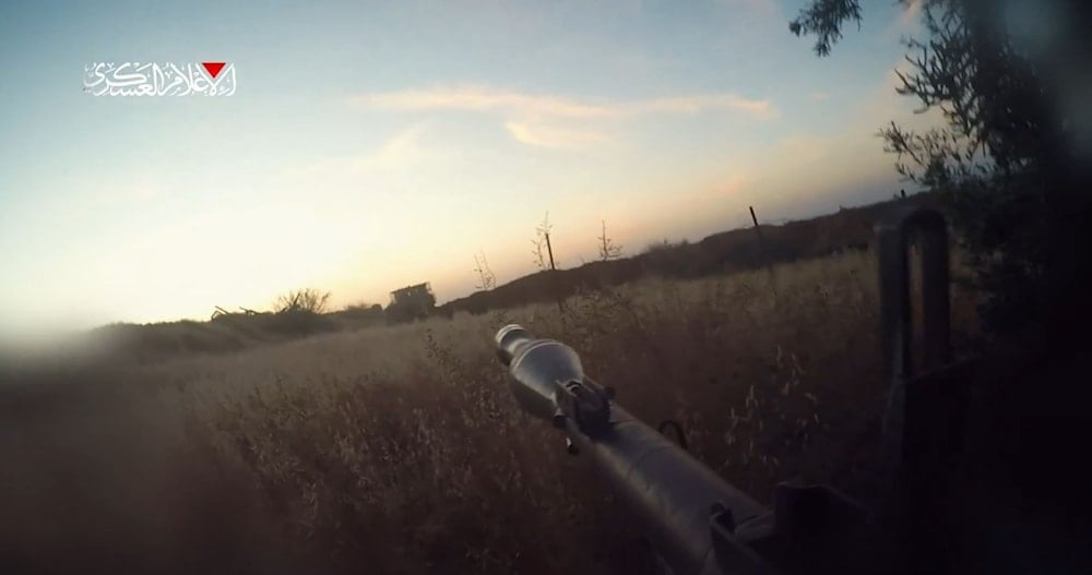 An Al-Qassam Brigade fighters targets a 
