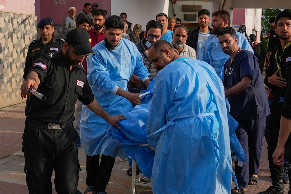 Paramedics carry a wounded tourist on a stretcher at a hospital in Anantnag after assailants indiscriminately fired at tourists visiting Pahalgam, Indian controlled Kashmir, Tuesday, April 22, 2025. (AP)