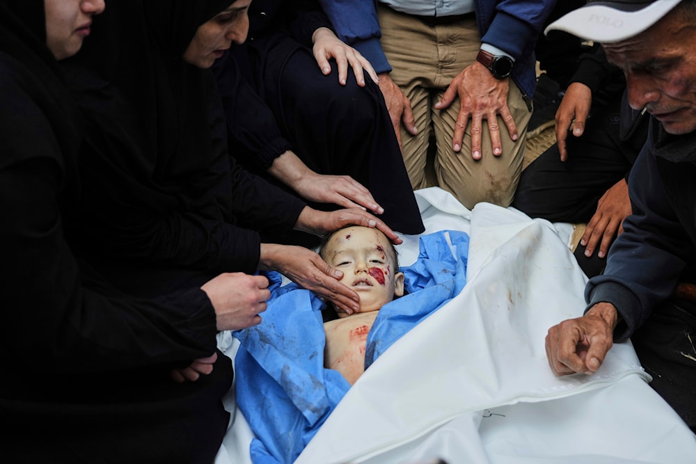 Palestinians mourn over the body of Kinan Edwan, 2 years old, killed in an Israeli army airstrike, during his funeral in Khan Younis, southern Gaza Strip, Saturday, April 19, 2025. (AP)