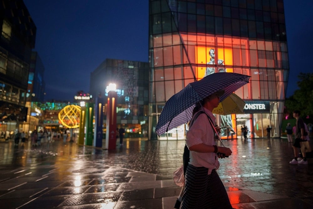 People shop at Taikoo Li Sanlitun in Beijing, China, Tuesday, July 2, 2024 (AP)