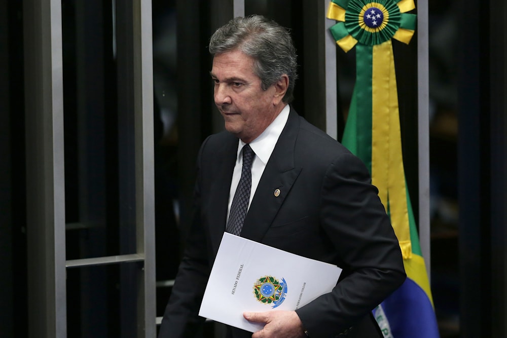 Brazil's former President Fernando Collor de Mello walks after speak during the impeachment trial of Brazil's suspended President Dilma Rousseff in Senate chambers, in Brasilia, Brazil, Tuesday, Aug. 30, 2016 (AP)