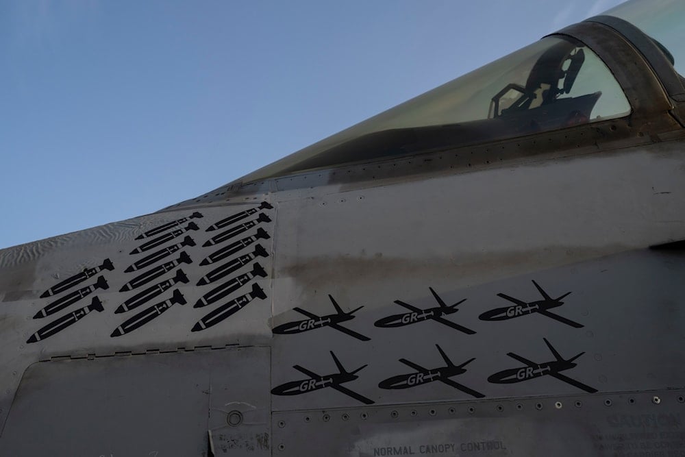 Drawings of drones and missiles that have been shot down are painted on the fuselage of a fighter jet stationed on the USS Dwight D. Eisenhower, also known as