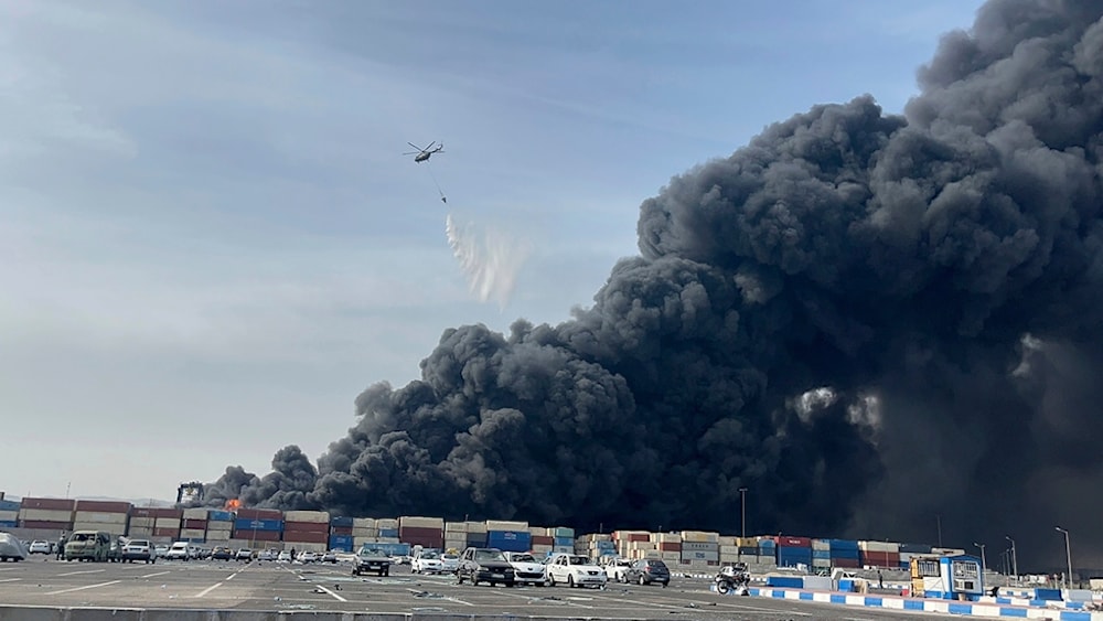 In this photo provided by Iranian Students' News Agency, ISNA, a helicopter drops water on the fire after a massive explosion rocked a port near the southern port city of Bandar Abbas, Iran, Saturday, April 26, 2025 (AP)