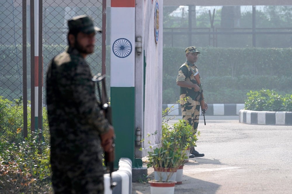 Pakistan's, left, and Indian paramilitary soldier, right, stand guard on their sides at the Kartarpur border crossing point, in Kartarpur, Pakistan, Tuesday, Nov. 19, 2024. (AP)