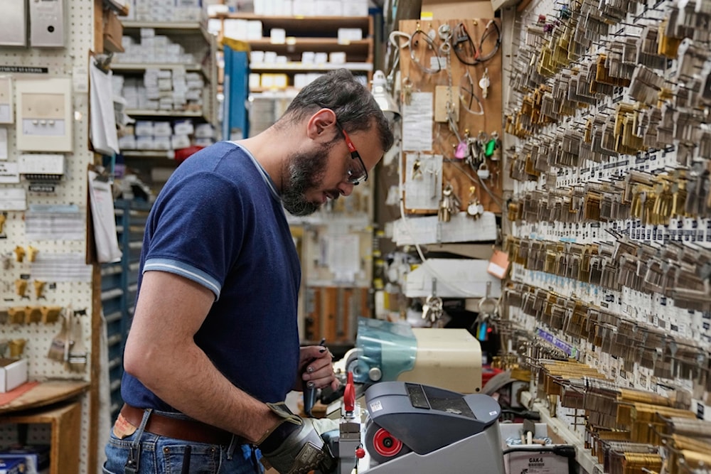 Employee Jon Vazquez-DeAnda cuts keys for a customer at employee-owned Clark Devon Hardware, Wednesday, April 2, 2025, in Chicago, US (AP Photo/Erin Hooley)