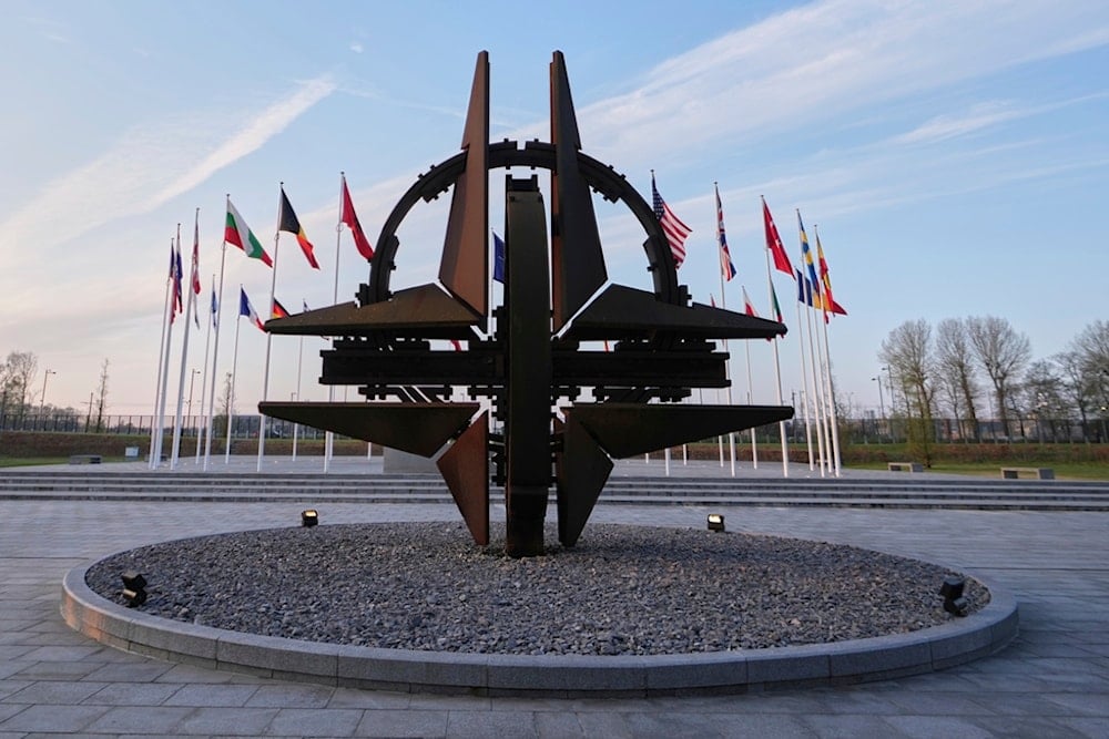 Flags of Alliance members flap in the wind prior to a meeting of NATO foreign ministers at NATO headquarters in Brussels, Thursday, April 3, 2025. (AP Photo/Virginia Mayo)
